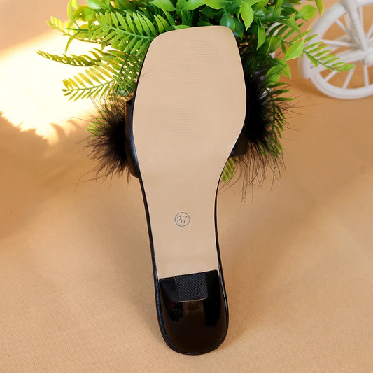 A pair of black women's casual high heels with soft chicken hair design and black high-heeled sandals