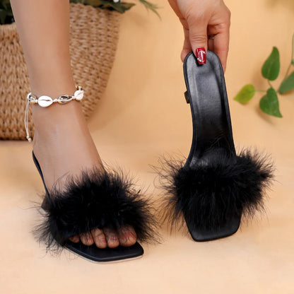 A pair of black women's casual high heels with soft chicken hair design and black high-heeled sandals