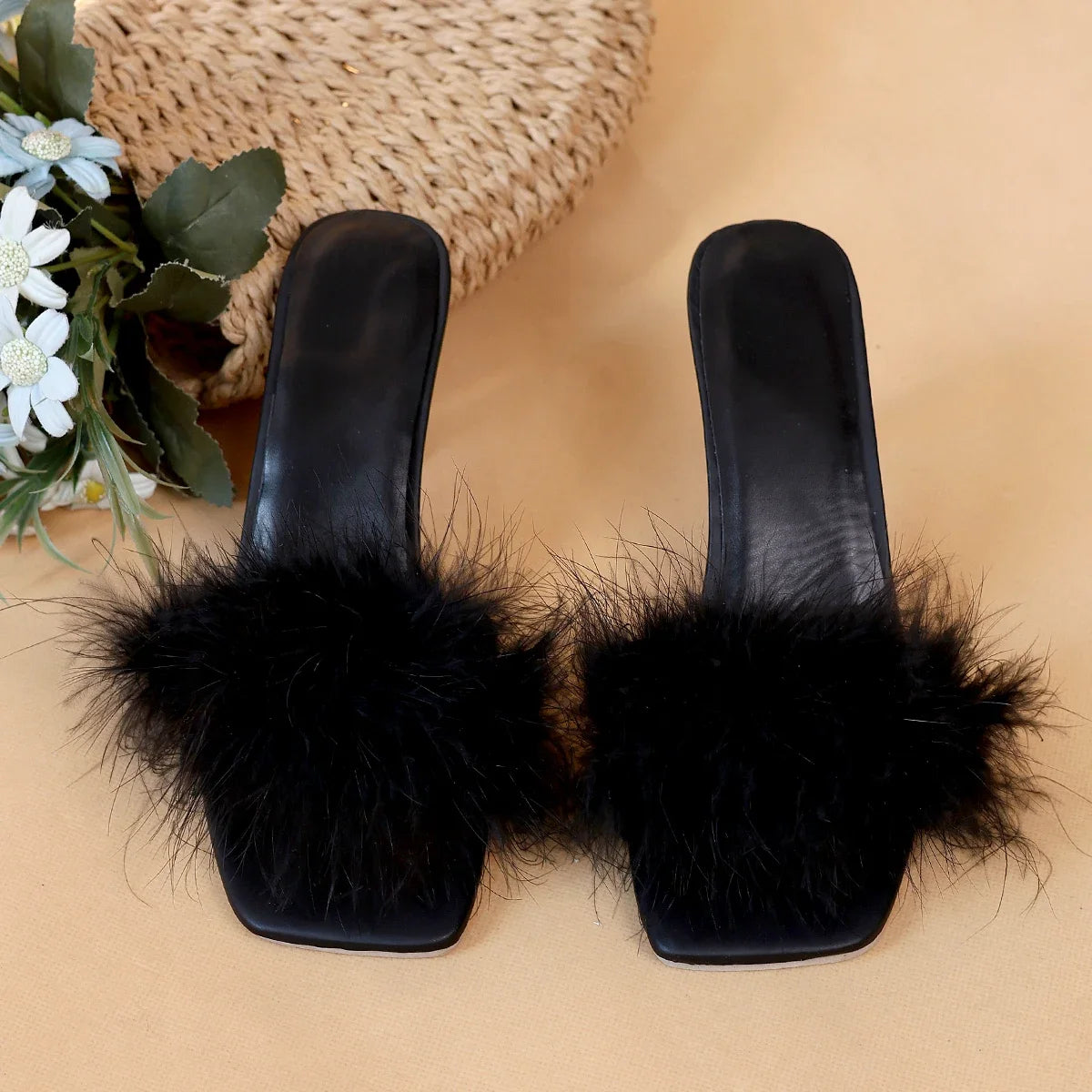 A pair of black women's casual high heels with soft chicken hair design and black high-heeled sandals